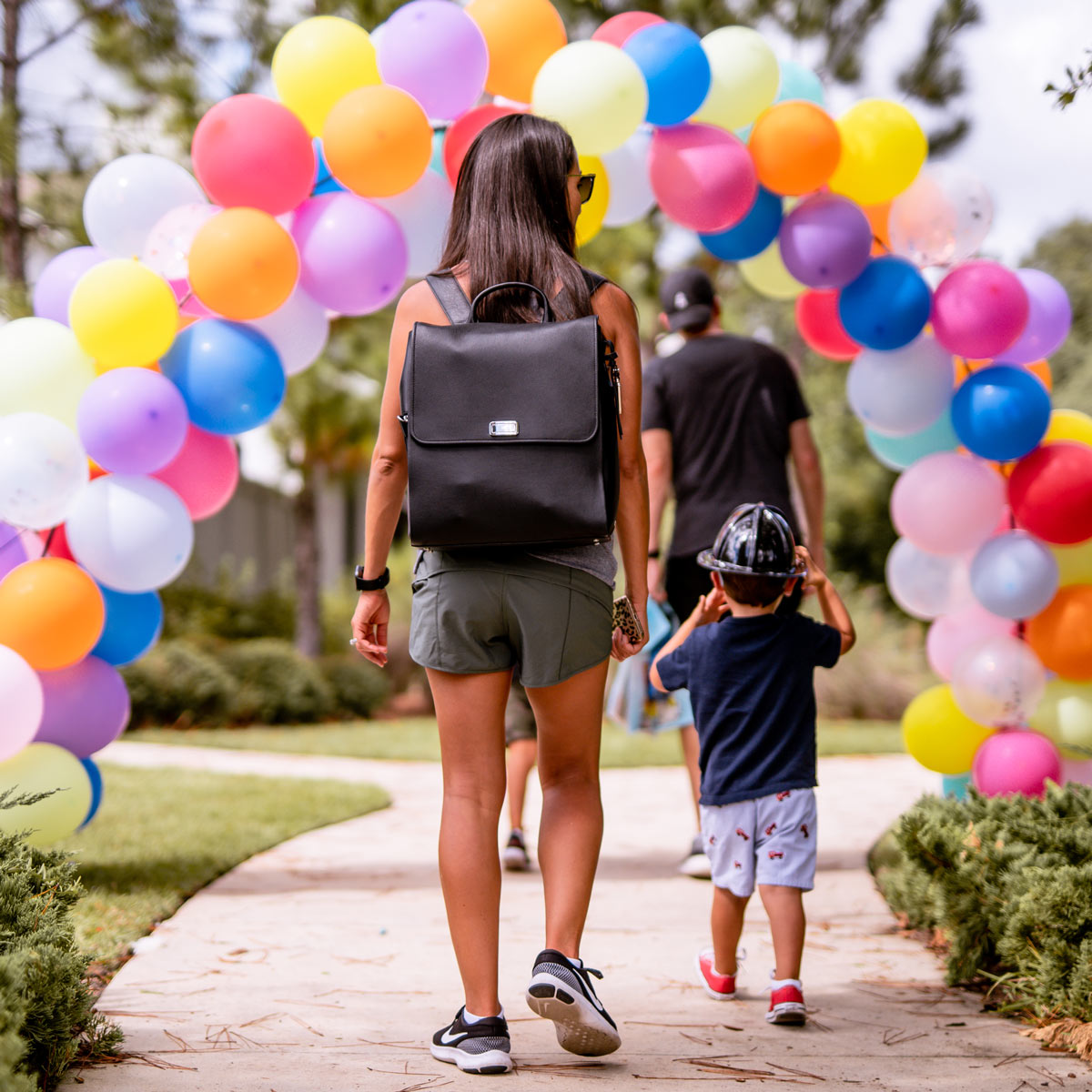 Boy in fire hat walking with mom