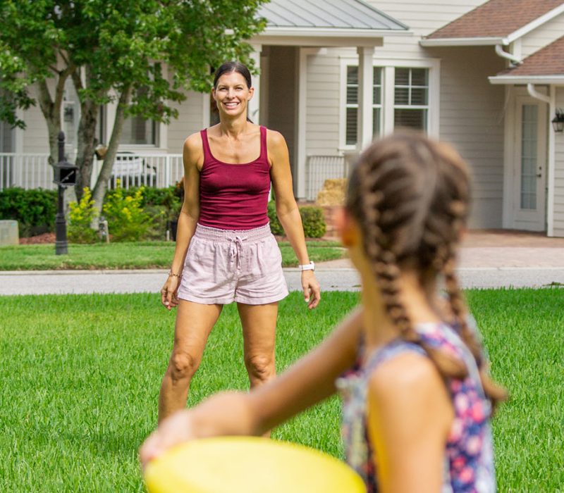 mom and daughter playing frisbee