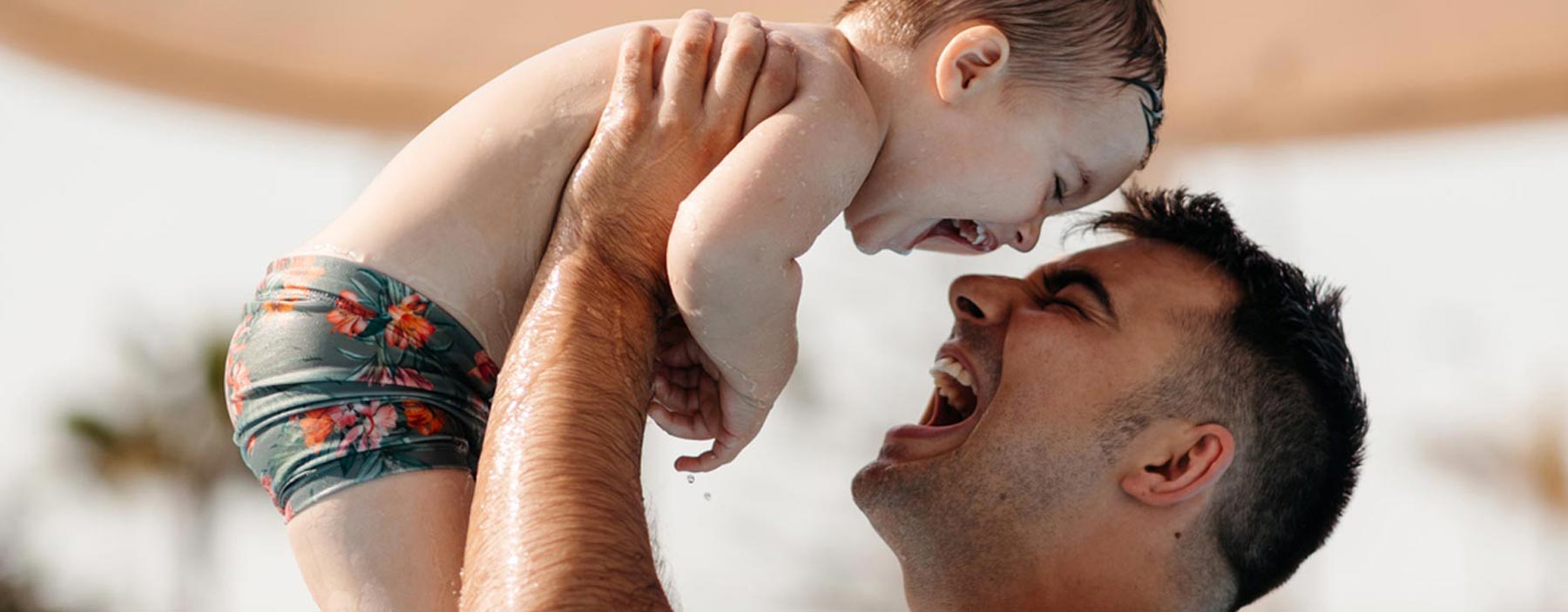 Father and son playing in pool